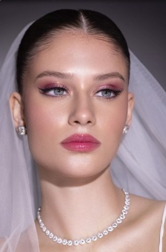Soft and natural bridal makeup with pink lip and veil
