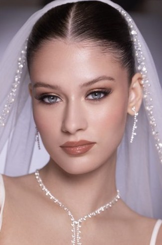 Classic bridal glam makeup with veil and pearl necklace