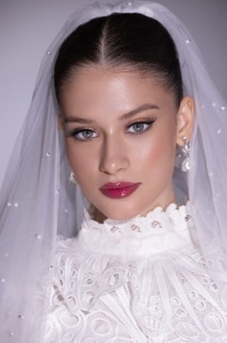 Bride in high-neck lace gown, bridal makeup Dubai